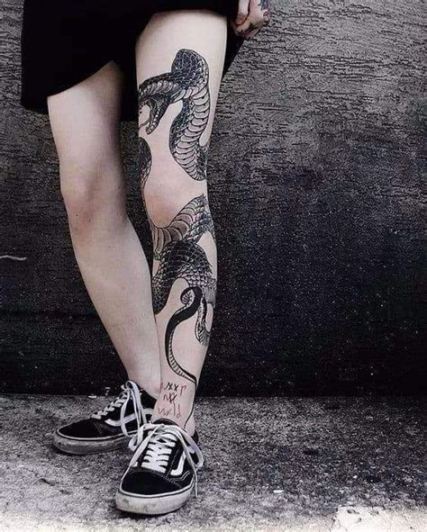 snake wrapping around leg tattoo.